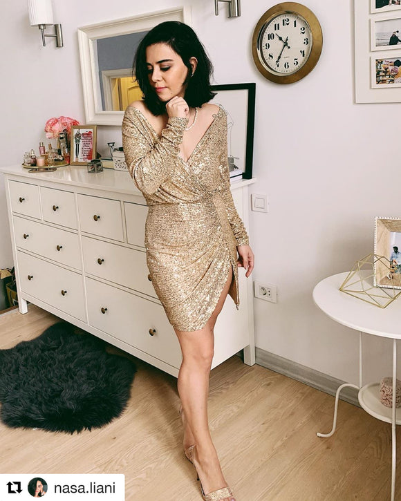 Shimmering Dress is a girl's dream dress. Drenched in gold sequins with slit on the side. This high-voltage dress features a modest, yet elegant silhouette. Fully lined. 
